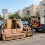 צוות מקצועי של חברת פינוי דירות מפנה ספה ורהיטים ישנים מרחוב בפתח תקווה בצורה מסודרת.